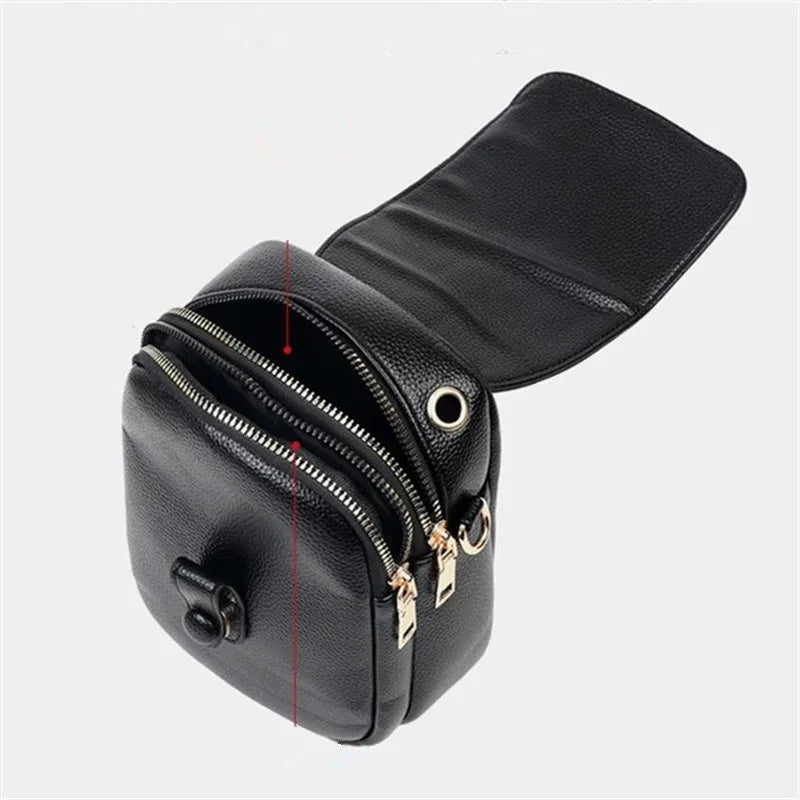 Kompakte Damen-Umhängetasche aus Leder mit minimalistischem Design und verstellbarem Riemen.